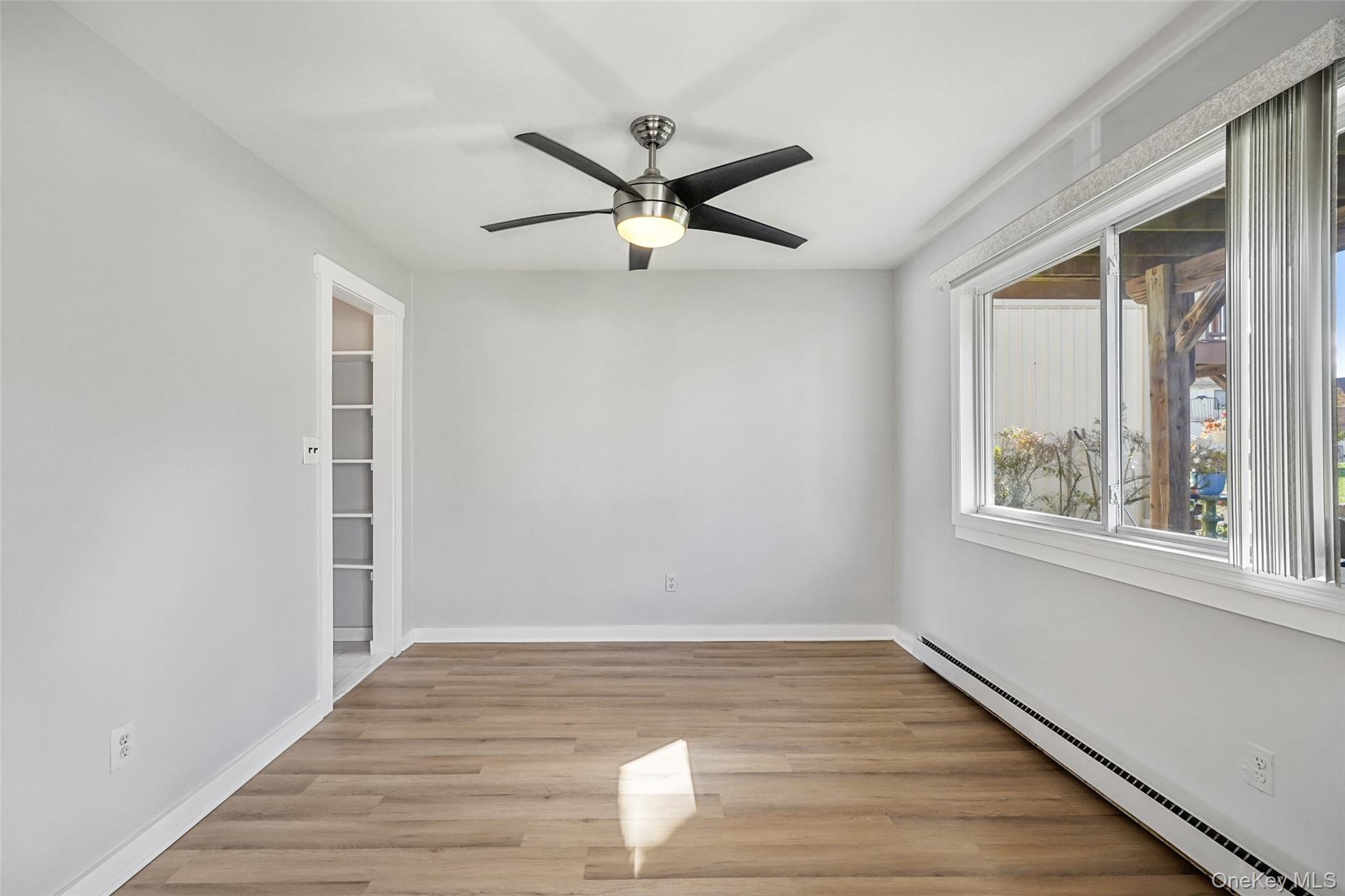 9 C Kings Court, Unit C Mohegan Lake, NY 10547 - Photo 8 of 31 wooden floor in an empty room with a window