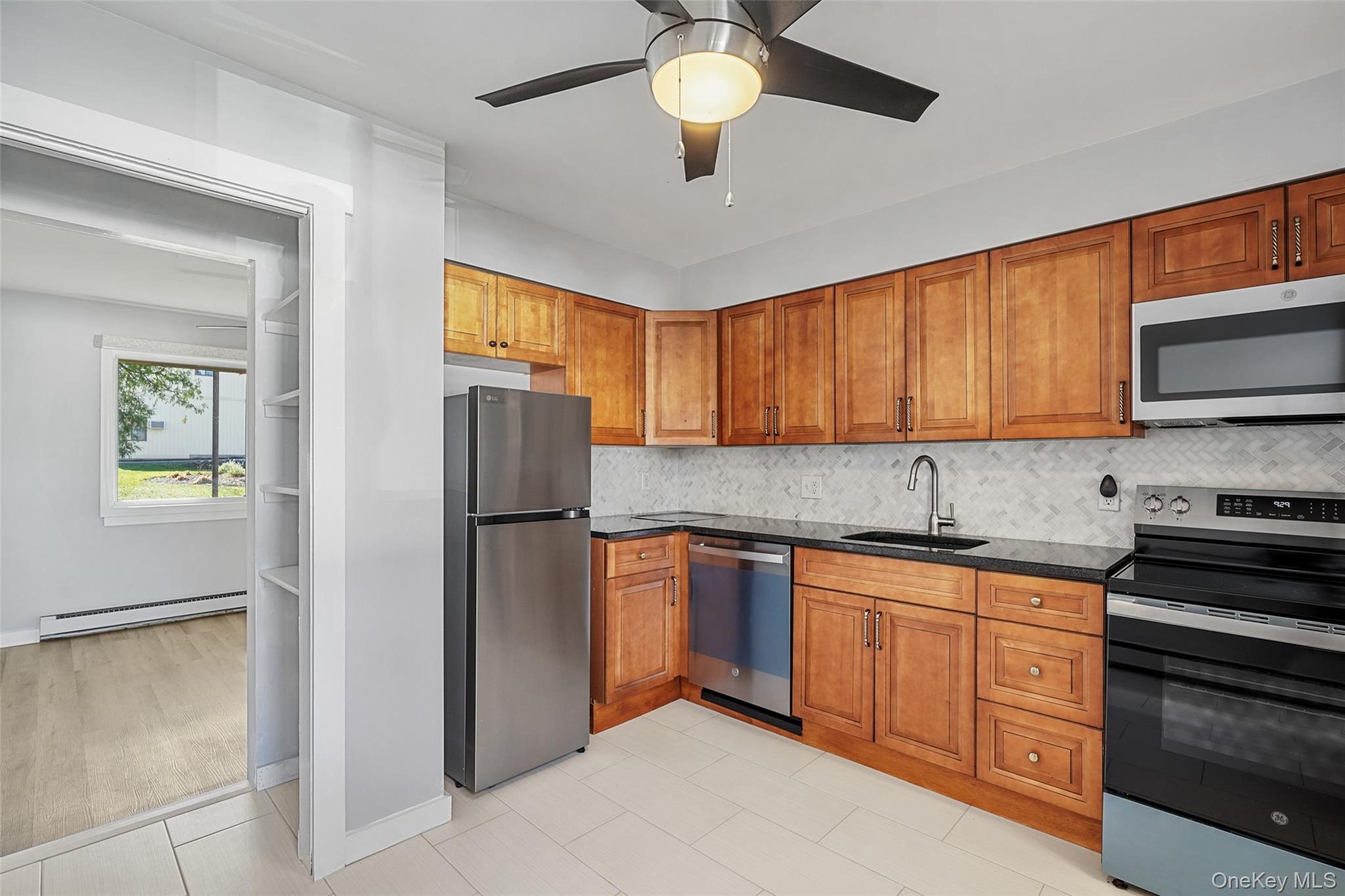 9 C Kings Court, Unit C Mohegan Lake, NY 10547 - Photo 9 of 31 a kitchen with stainless steel appliances granite countertop a refrigerator and a stove top oven