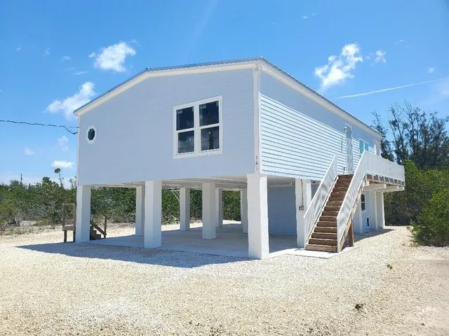 a view of roof deck with two chairs and wooden fence