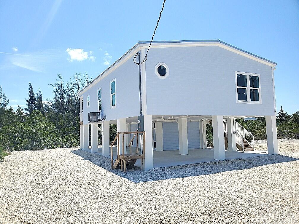 231 Pelican Lane Big Pine Key, FL 33043 - Photo 7 of 11 a view of a house with backyard porch and sitting area
