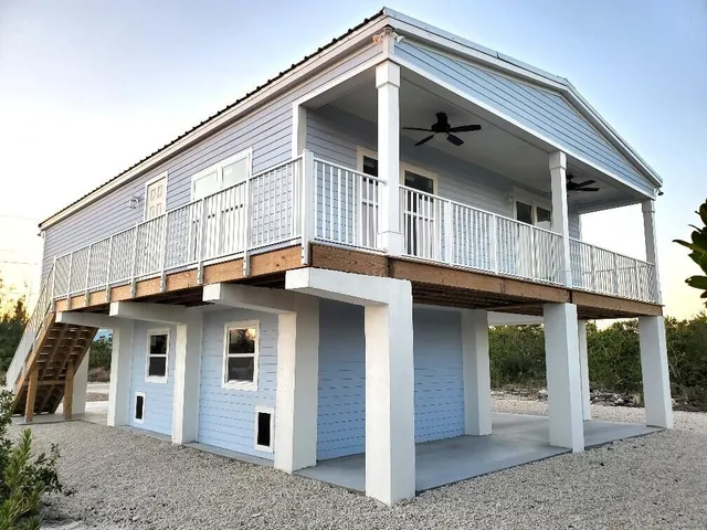 a view of a golf ground with large trees