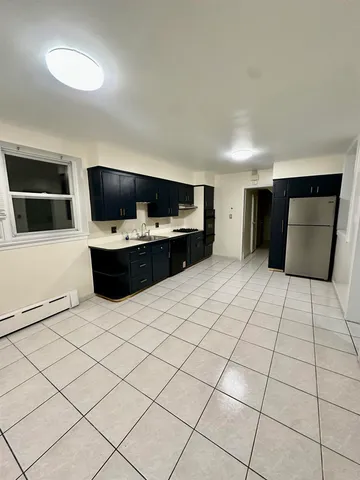 a living room with a large window and a flat screen tv