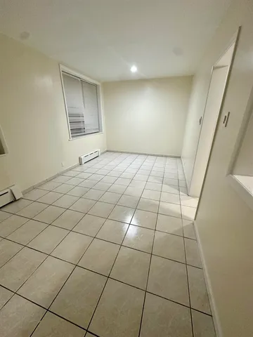 a view of an empty room and a window