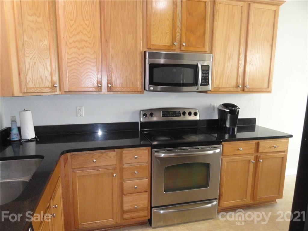 771 Prospect Lane, Unit 33 Fort Mill, SC 29708 - Photo 7 of 23 a kitchen with stainless steel appliances granite countertop a sink and a microwave