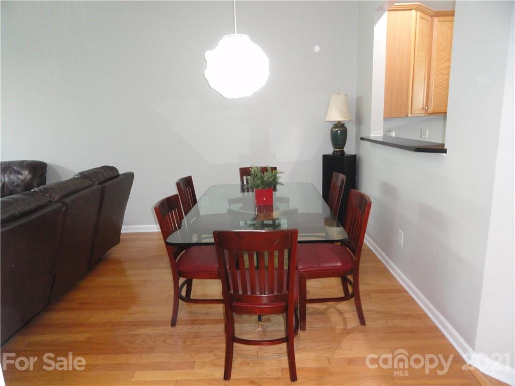 771 Prospect Lane, Unit 33 Fort Mill, SC 29708 - Photo 8 of 23 a view of a dining room with furniture and wooden floor