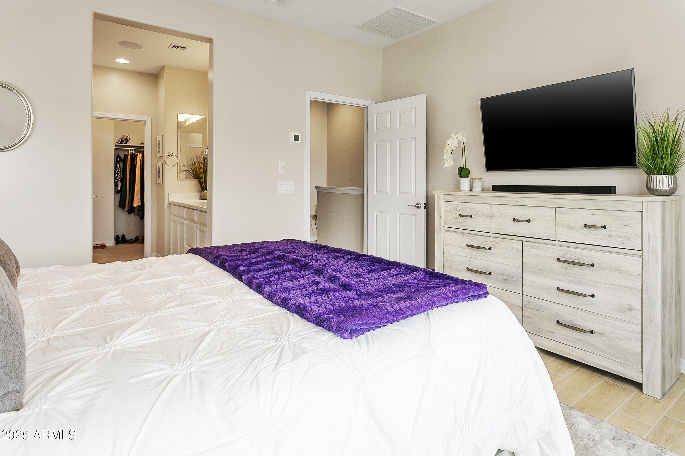 1661 East Hampton Lane Gilbert, AZ 85295 - Photo 16 of 31 a bedroom with a bed and a flat screen tv in it