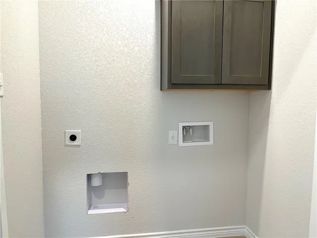 a room with a microwave and cabinets