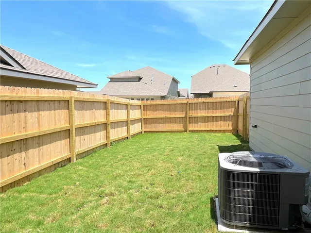 a view of backyard with seating area