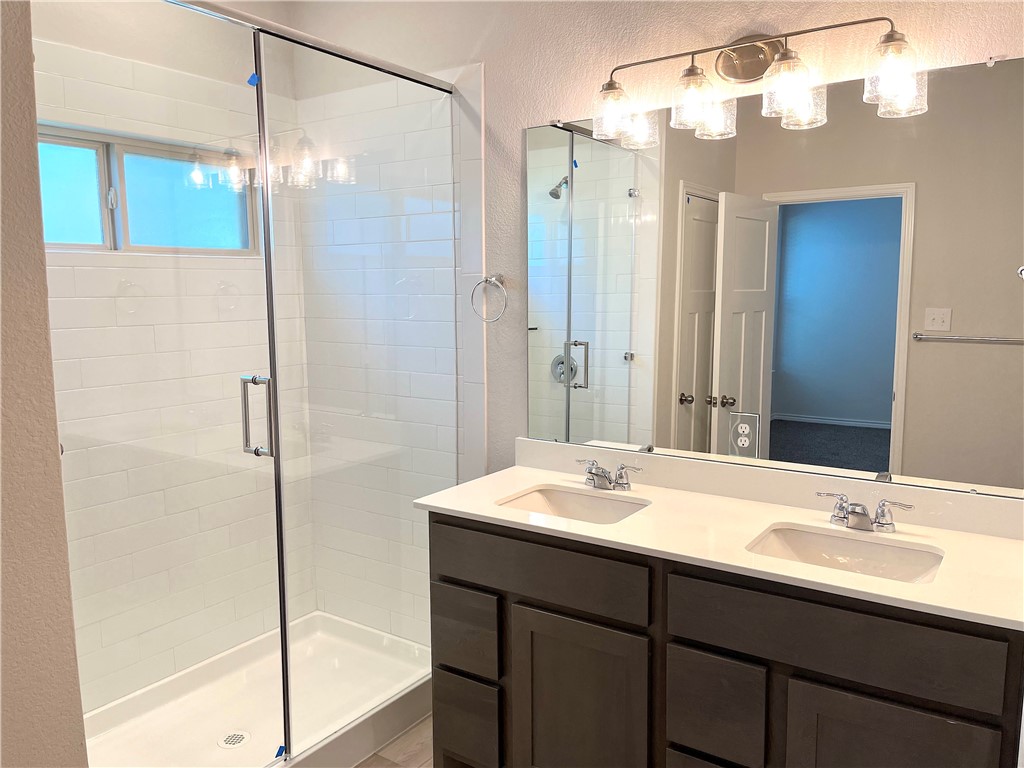 803 Double Mountain Road College Station, TX 77845 - Photo 8 of 17 a bathroom with a sink and a mirror