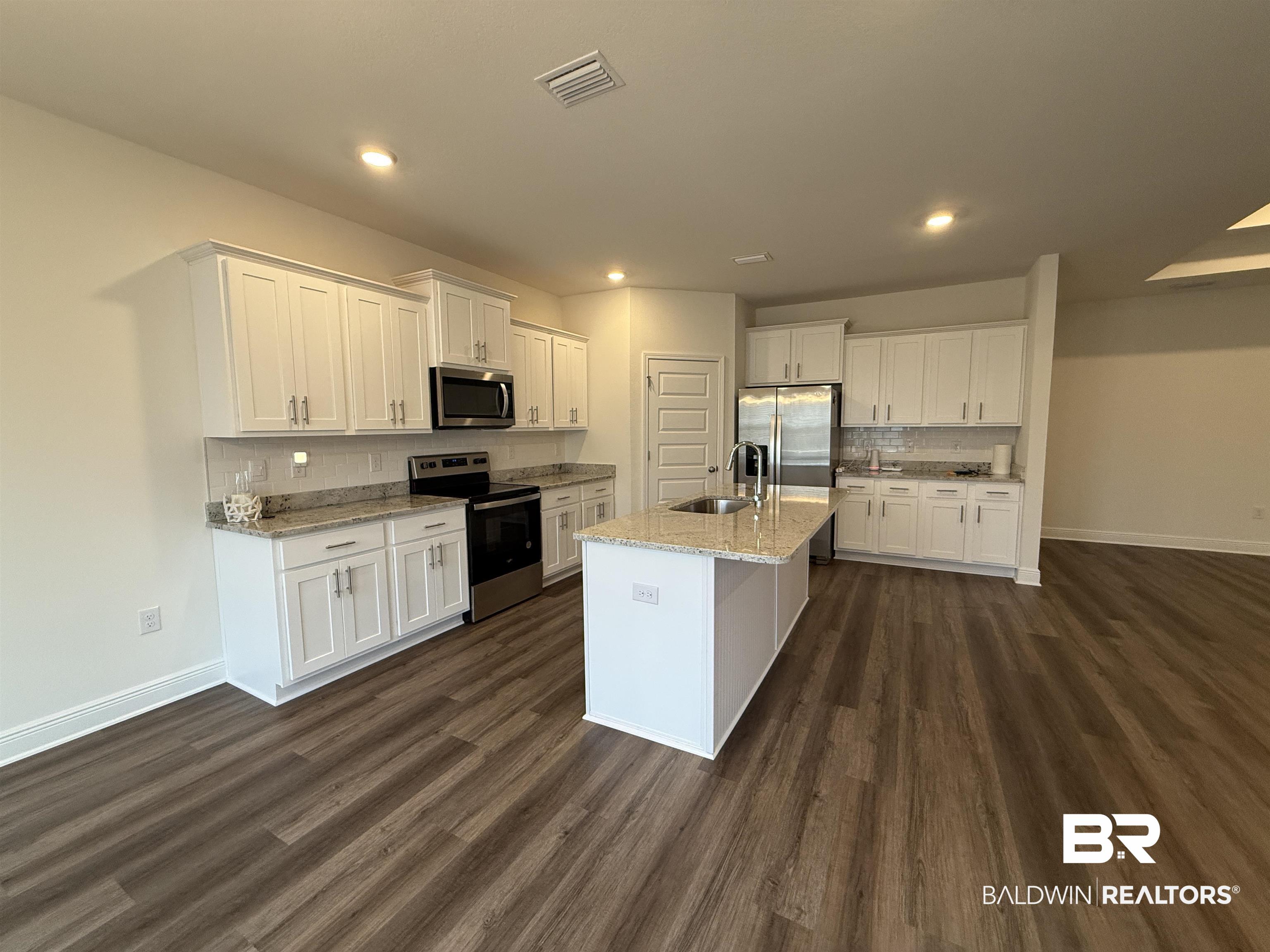 11442 Genuine Risk Circle Daphne, AL 36526 - Photo 6 of 21 Kitchen with stainless steel appliances, white cabinetry, tasteful backsplash, and recessed lighting