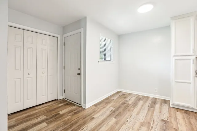 a kitchen with granite countertop a refrigerator stove top oven and cabinets