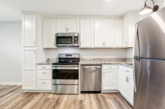 a kitchen with a sink and a refrigerator