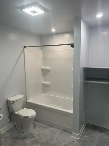 a bathroom with a double vanity sink toilet and shower