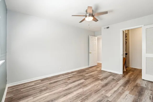 a view of a room with a fan and a window
