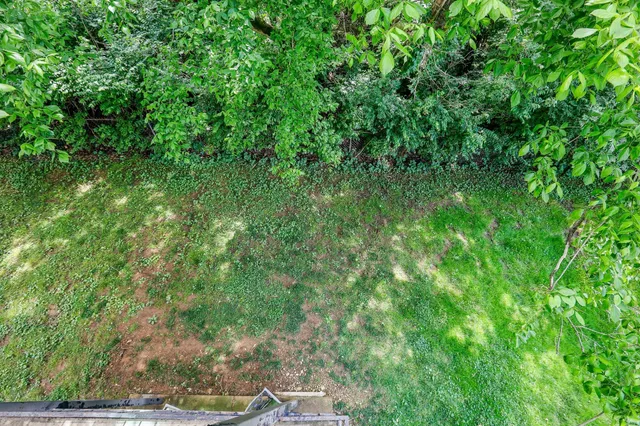 a view of balcony with wooden floor and fence