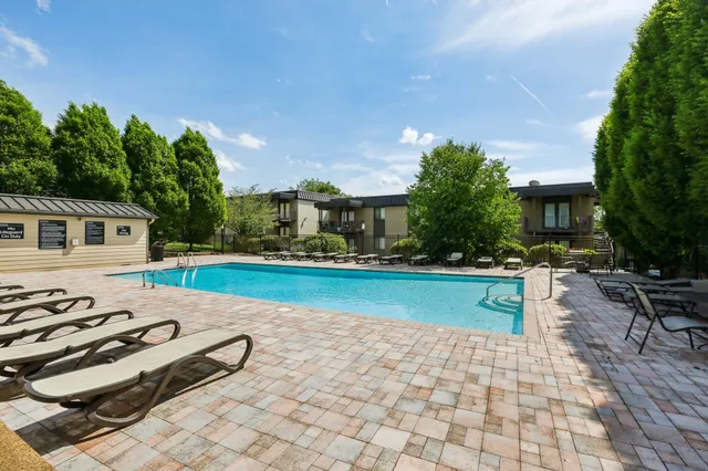 a view of a house with a backyard and a patio