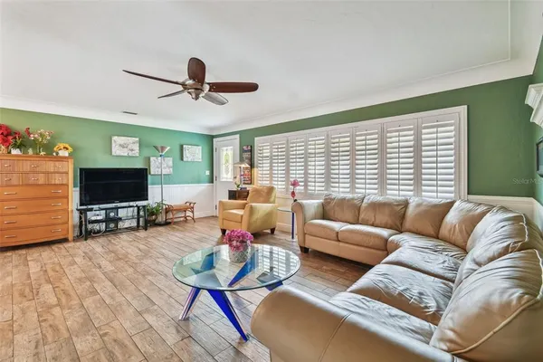 a living room with furniture and wooden floor
