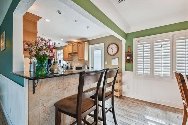 a kitchen with stainless steel appliances granite countertop a sink a stove counter space and cabinets
