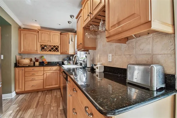 a kitchen with stainless steel appliances granite countertop a refrigerator and a stove top oven