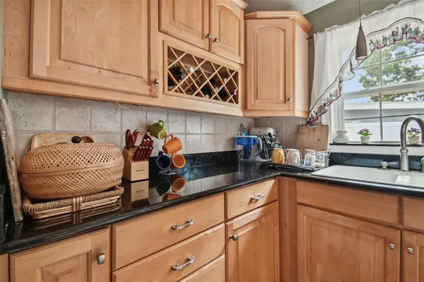 a kitchen with stainless steel appliances granite countertop a sink and cabinets