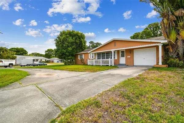 a view of house with yard and entertaining space