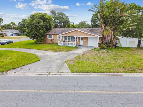 a front view of house with yard and green space