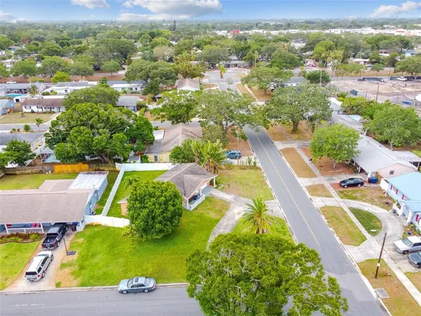 an aerial view of residential houses with outdoor space and swimming pool