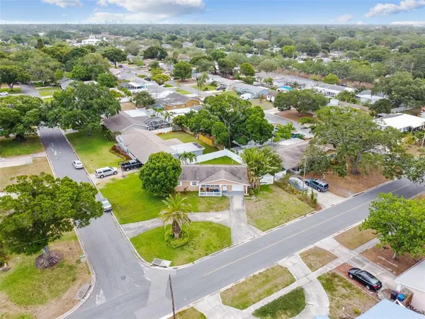 an aerial view of residential houses with outdoor space and swimming pool