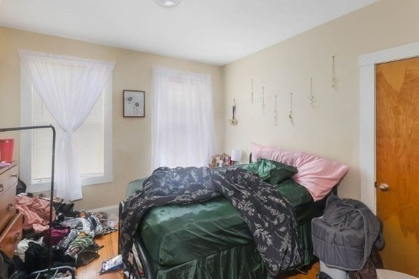 171 Mechanic Street Southbridge, MA 01550 - Photo 12 of 37 a bed room with a bed and a chair