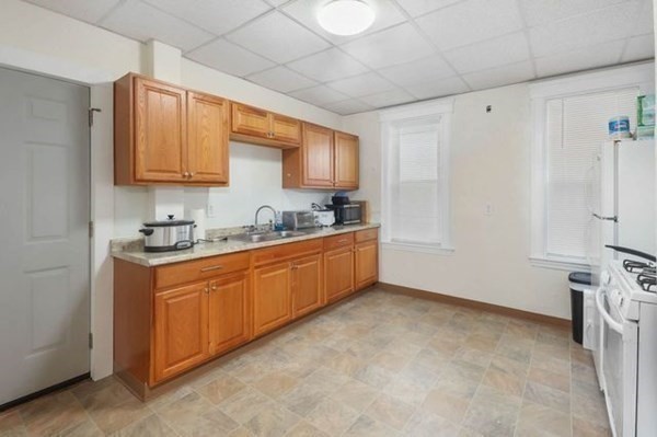 171 Mechanic Street Southbridge, MA 01550 - Photo 16 of 37 a kitchen with stainless steel appliances granite countertop a sink a stove and a refrigerator