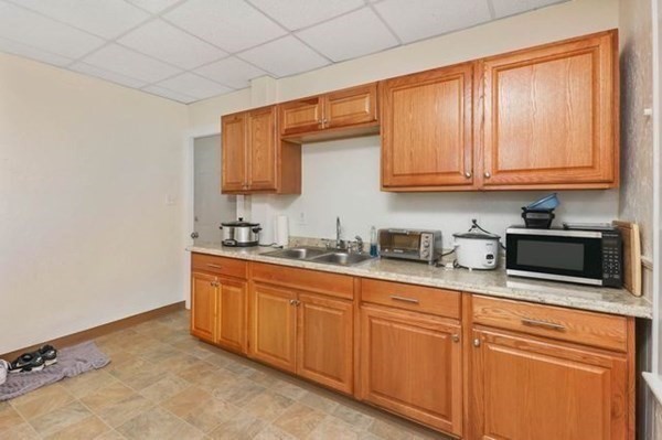 171 Mechanic Street Southbridge, MA 01550 - Photo 17 of 37 a kitchen with stainless steel appliances granite countertop a sink a stove and cabinets