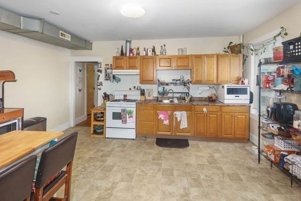 171 Mechanic Street Southbridge, MA 01550 - Photo 6 of 37 a kitchen with cabinets and appliances