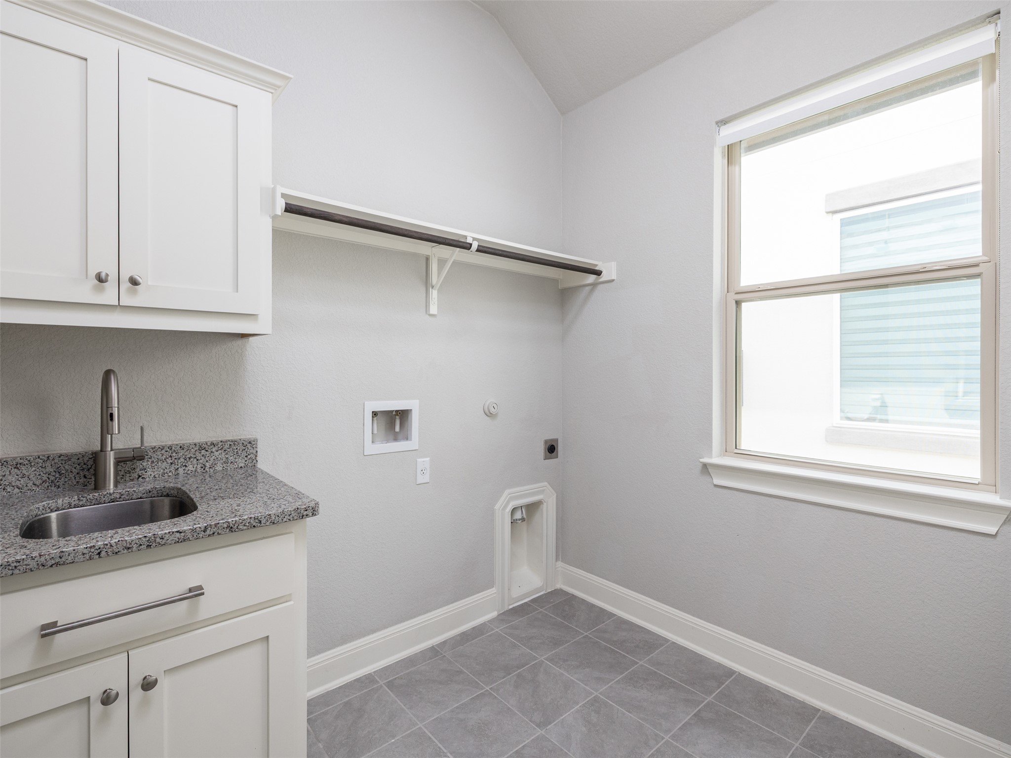 1329 Siena Sunset Road Leander, TX 78641 - Photo 28 of 40 Laundry room with sink and hookups for both washer & dryer