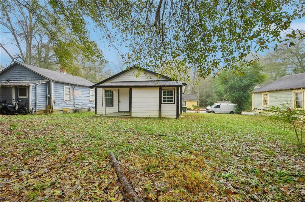 5160 Avery Street Southwest Covington, GA 30014 - Photo 22 of 23 a front view of a house with a garden