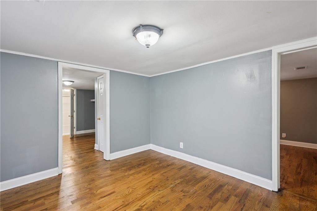 5160 Avery Street Southwest Covington, GA 30014 - Photo 8 of 23 a view of empty room with wooden floor