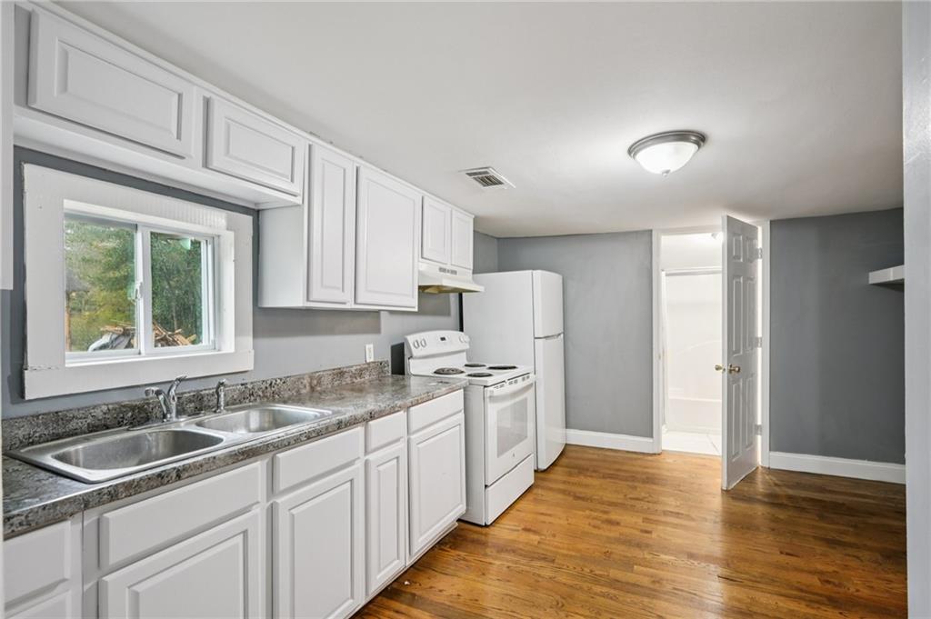 5160 Avery Street Southwest Covington, GA 30014 - Photo 9 of 23 a kitchen with a sink stove and cabinets