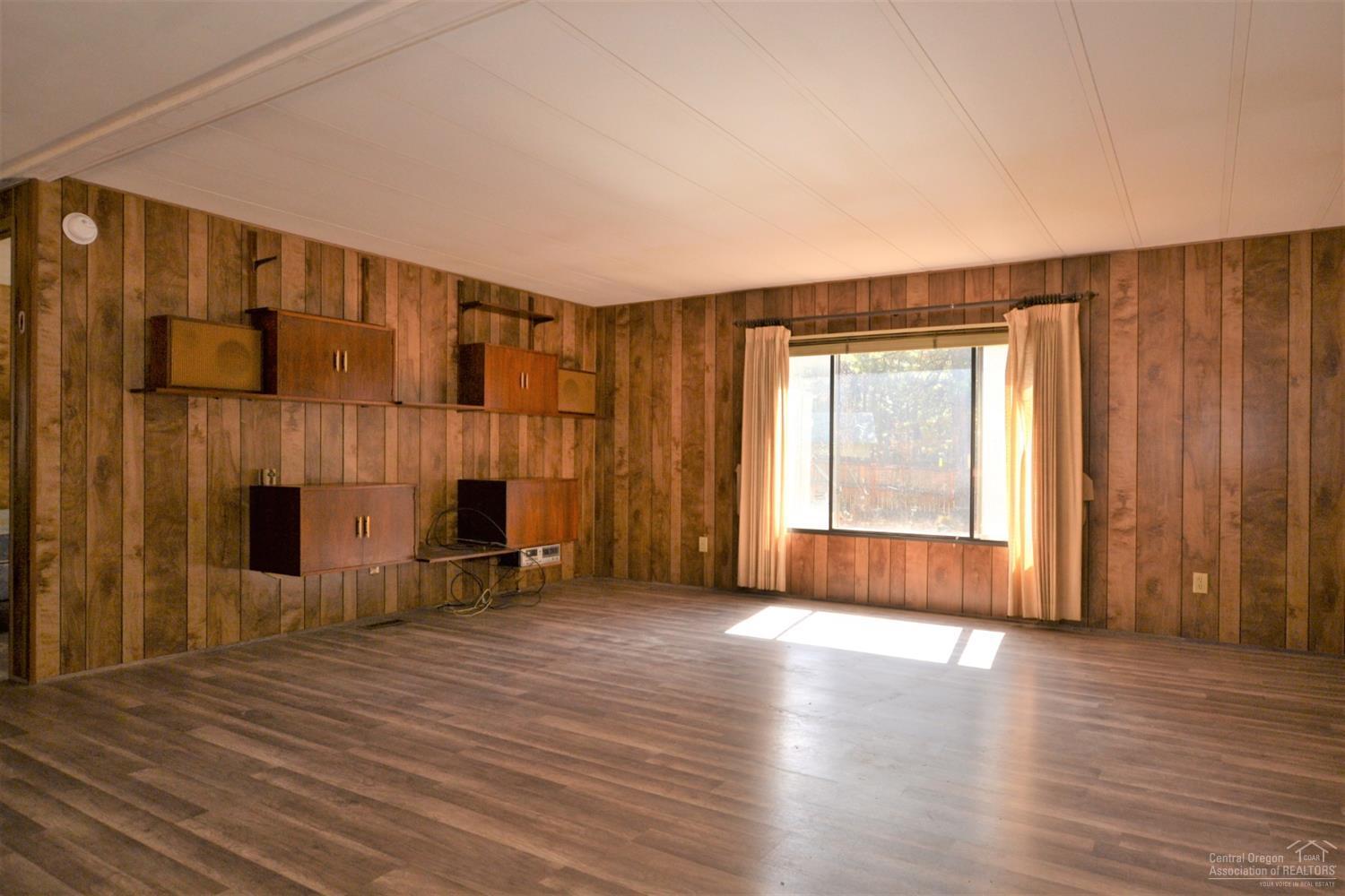 60176 Agate Road Bend, OR 97702 - Photo 7 of 21 a view of a livingroom with wooden floor and a fireplace
