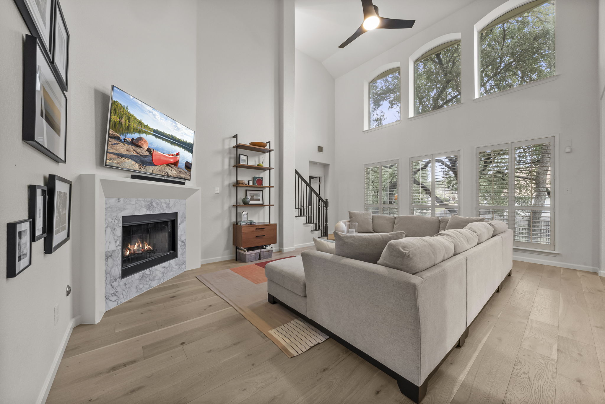 a living room with furniture a fireplace and a flat screen tv