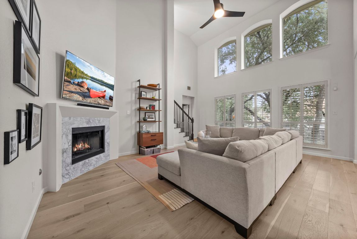 1912 Wildfire Leander, TX 78641 - Photo 11 of 40 a living room with furniture a fireplace and a flat screen tv