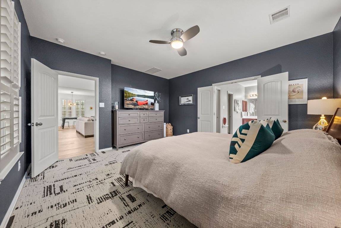 1912 Wildfire Leander, TX 78641 - Photo 15 of 40 a bedroom with a bed and a large mirror