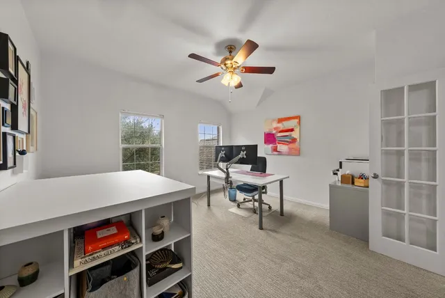 a workspace with furniture and a chandelier