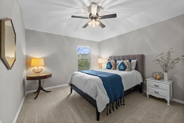 a spacious bedroom with a bed and furniture