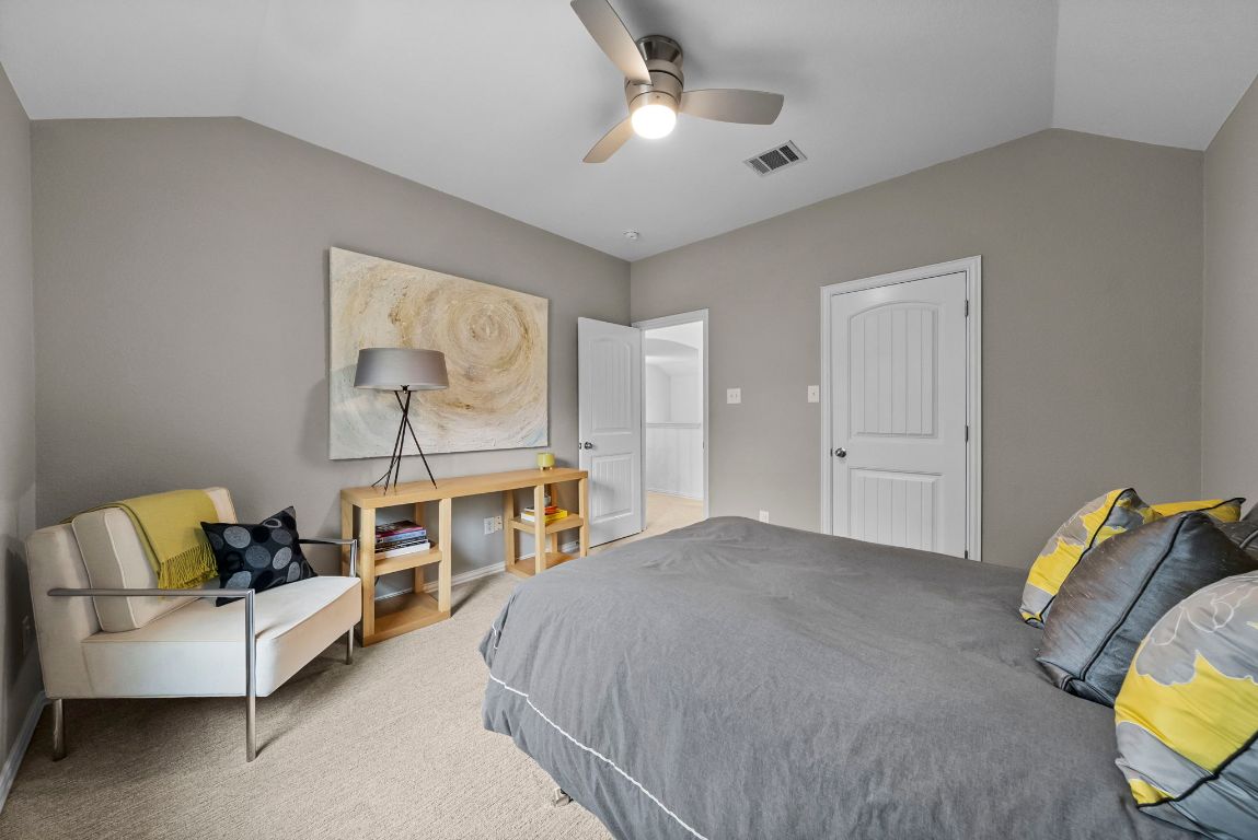 1912 Wildfire Leander, TX 78641 - Photo 22 of 40 a spacious bedroom with a bed and furniture