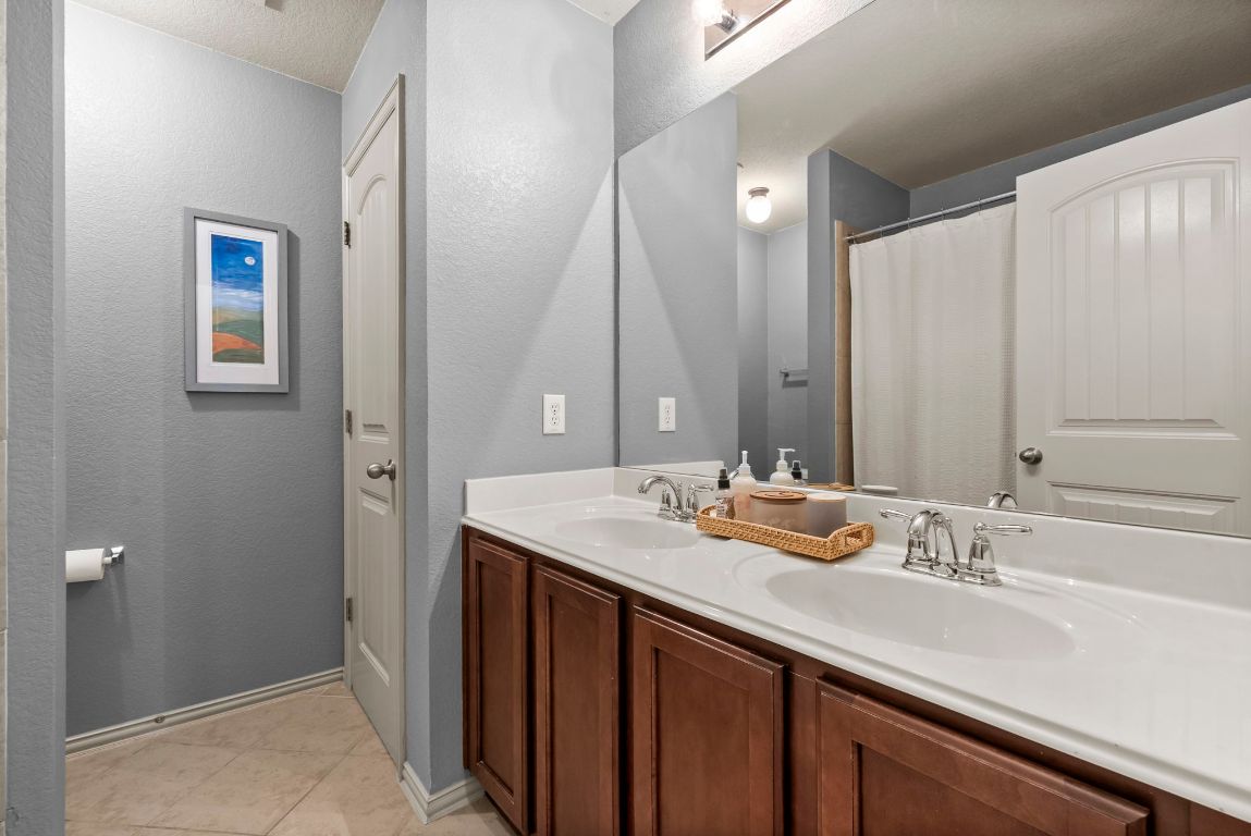 1912 Wildfire Leander, TX 78641 - Photo 23 of 40 a bathroom with a sink and a mirror