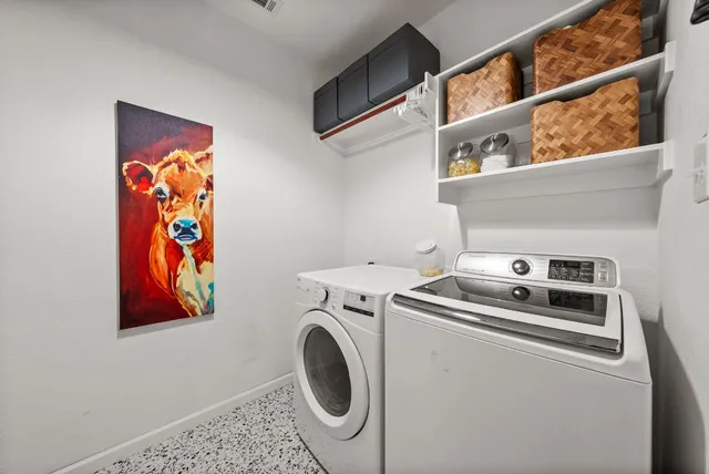 a view of a patio with table and chairs potted plants and a large tree