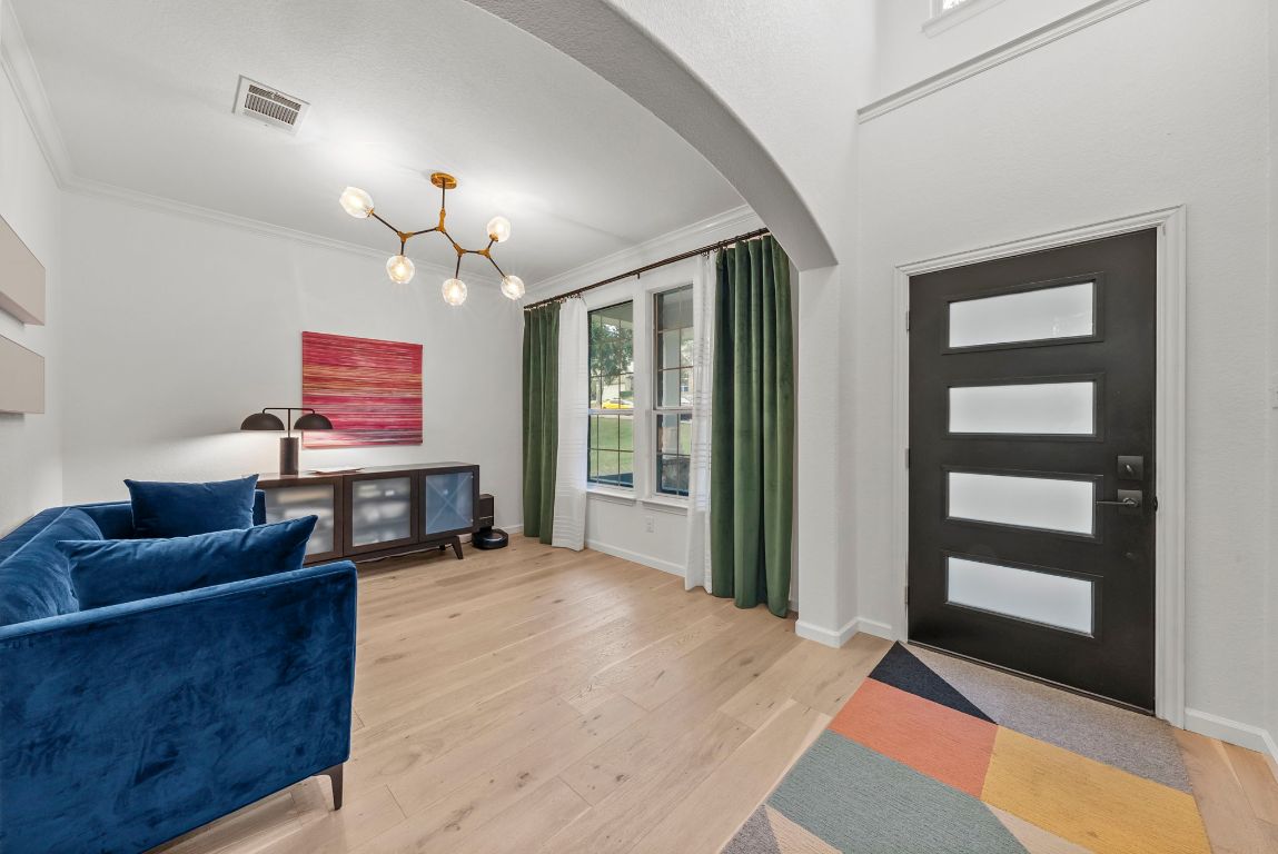 1912 Wildfire Leander, TX 78641 - Photo 3 of 40 a living room with furniture a chandelier and a flat screen tv