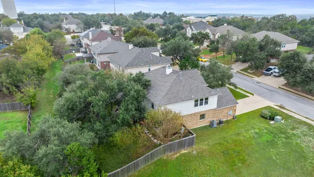 an aerial view of a house with roof deck and outdoor seating