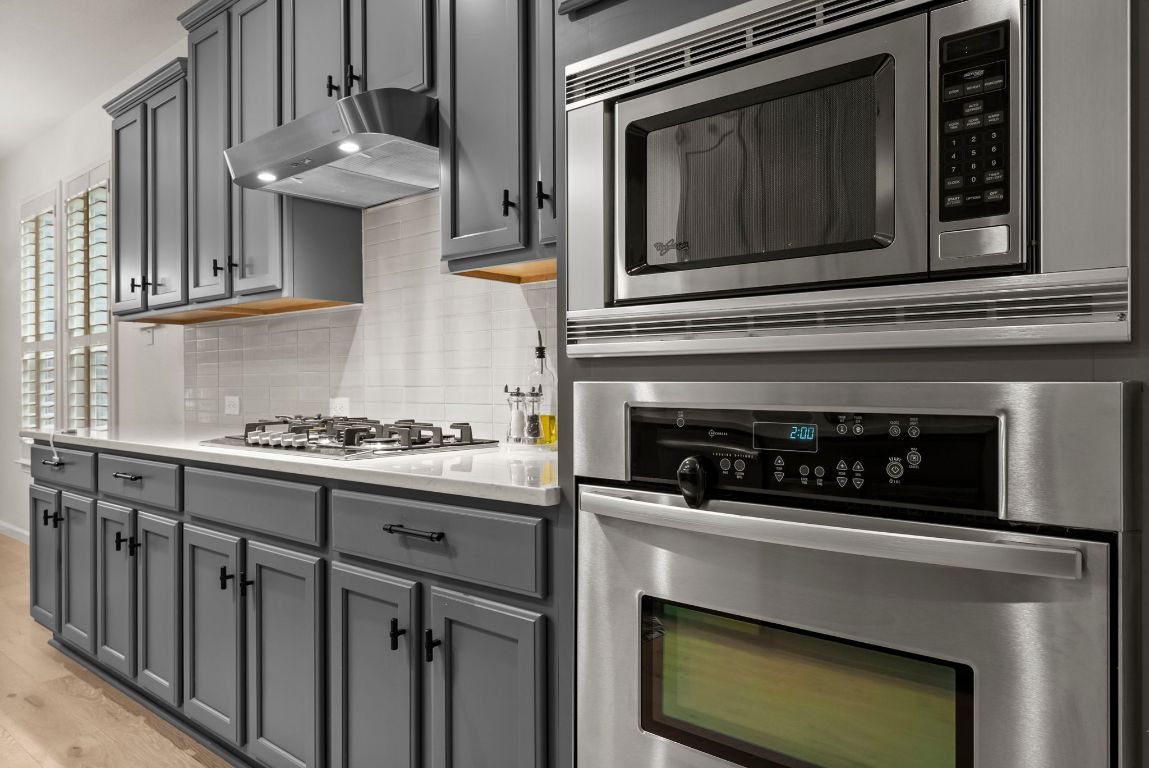 1912 Wildfire Leander, TX 78641 - Photo 7 of 40 a kitchen with cabinets and a stove top oven