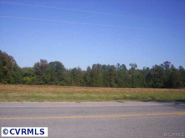a view of a field with trees in the background