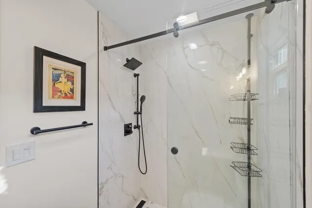a bathroom with a shower and a glass shower